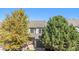 A two-story home with mature trees and a well-maintained yard presents curb appeal at 2215 E 103Rd Pl, Thornton, CO 80229