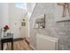 Bright foyer features wood floors, and a decorative brick wall with modern decor at 2215 E 103Rd Pl, Thornton, CO 80229