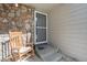 Welcoming front porch with rocking chair and stone accents offers a cozy feel at 2215 E 103Rd Pl, Thornton, CO 80229