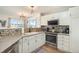 Updated kitchen featuring white cabinets, stainless steel appliances, and modern backsplash at 2215 E 103Rd Pl, Thornton, CO 80229