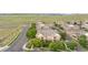 Aerial view showcases the townhome buildings with lush green trees and convenient parking spaces at 23456 E 5Th Pl # 104, Aurora, CO 80018