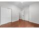 Bedroom with hardwood floors, closet, and open doorway at 23456 E 5Th Pl # 104, Aurora, CO 80018