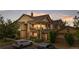 Beautiful two-story condo with a covered balcony, brick accents, and well-maintained landscaping with assigned parking at 23456 E 5Th Pl # 104, Aurora, CO 80018