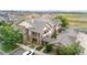 Exterior view of a charming townhome with a private balcony and landscaped front yard at 23456 E 5Th Pl # 104, Aurora, CO 80018