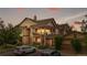 Condo building exterior with multiple balconies and well-maintained landscaping at sunset at 23456 E 5Th Pl # 104, Aurora, CO 80018