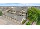 Exterior angle featuring the townhome garages with attached garages and manicured landscaping at 23456 E 5Th Pl # 104, Aurora, CO 80018