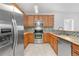 Well-equipped kitchen with stainless steel appliances, wooden cabinets, and tiled backsplash at 23456 E 5Th Pl # 104, Aurora, CO 80018