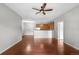 Spacious living room showcasing an open floor plan with a ceiling fan and hardwood floors at 23456 E 5Th Pl # 104, Aurora, CO 80018