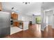 Open-concept living area with hardwood floors, a fireplace, and sliding glass doors to a private balcony at 23456 E 5Th Pl # 104, Aurora, CO 80018