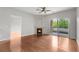 Living room showcasing a fireplace, ceiling fan, and sliding glass doors to a private balcony at 23456 E 5Th Pl # 104, Aurora, CO 80018