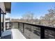 The balcony has black metal railings and a view of the street and trees at 345 Fillmore St # 409, Denver, CO 80206