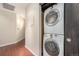 Convenient laundry area with stacked washer and dryer in a narrow hallway at 345 Fillmore St # 409, Denver, CO 80206
