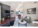 Cozy living room with a fireplace, large windows, hardwood floors, and a dining area view at 345 Fillmore St # 409, Denver, CO 80206