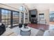 Spacious living room featuring a fireplace, large windows with city views, and hardwood floors at 345 Fillmore St # 409, Denver, CO 80206