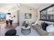Bright living room area featuring hardwood floors, stylish furniture, and views to the dining area at 345 Fillmore St # 409, Denver, CO 80206