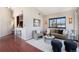 Bright living room featuring an open floor plan, modern furniture, hardwood floors and stylish decor at 345 Fillmore St # 409, Denver, CO 80206