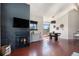 Bright living room featuring a fireplace, tv, hardwood floors, and a dining area at 345 Fillmore St # 409, Denver, CO 80206