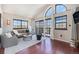 Open living room with high ceilings, large windows, hardwood floors, and contemporary furnishings at 345 Fillmore St # 409, Denver, CO 80206