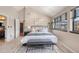 Vaulted main bedroom featuring neutral walls and an ensuite bathroom and walk-in closets at 345 Fillmore St # 409, Denver, CO 80206