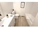 Bright bathroom with a modern vanity, stylish fixtures, and a bathtub with subway tile surround at 5721 W 92Nd Ave # 66, Westminster, CO 80031