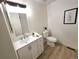 Well-lit bathroom featuring a contemporary vanity, framed mirror, and neutral color scheme with wood look floors at 5721 W 92Nd Ave # 66, Westminster, CO 80031