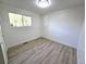 Bright, empty bedroom featuring sleek floors, white walls, and a view to the outdoors at 5721 W 92Nd Ave # 66, Westminster, CO 80031