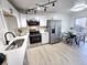 Modern kitchen boasts stainless steel appliances, white cabinetry, and sleek countertops at 5721 W 92Nd Ave # 66, Westminster, CO 80031