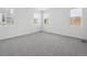 Spacious bedroom with soft gray carpet and an abundance of natural light from three windows at 2668 Simpson Ln, Erie, CO 80026