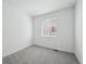 Cozy bedroom with gray carpet, a window providing natural light, and neutral-colored walls at 2668 Simpson Ln, Erie, CO 80026