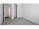 Bedroom showcasing plush carpet, a closet with sliding doors, and a doorway into another room at 2668 Simpson Ln, Erie, CO 80026
