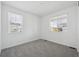 Cozy bedroom with plush carpeting and plenty of natural light from the large windows at 2668 Simpson Ln, Erie, CO 80026