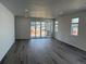 Bright, open-concept living room with hardwood floors and sliding glass doors that let in natural light at 2668 Simpson Ln, Erie, CO 80026