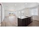 Open-concept living room with large windows and sliding glass doors leading to the outdoors at 2668 Simpson Ln, Erie, CO 80026