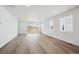 Spacious living area with wood floors, large windows, and natural light at 2668 Simpson Ln, Erie, CO 80026