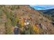 Aerial view of a stunning home nestled in the mountains, showcasing its architecture and surrounding landscape at 187 Fox Ridge Dr, Evergreen, CO 80439