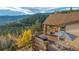 Spacious deck with mountain views, fire pit, and outdoor seating at 187 Fox Ridge Dr, Evergreen, CO 80439