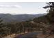 Paved driveway leading to a home with mountain views at 187 Fox Ridge Dr, Evergreen, CO 80439