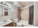 Cozy bathroom featuring a tub-shower combo, a vanity with storage, and a framed mirror with integrated shelves at 3653 S Sheridan Blvd # 16, Denver, CO 80235