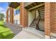 Exterior apartment stairs showcasing brick accents and well-kept landscaping at 3653 S Sheridan Blvd # 16, Denver, CO 80235