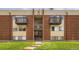 Brick apartment building featuring inviting balconies and well-maintained landscaping at 3653 S Sheridan Blvd # 16, Denver, CO 80235