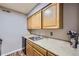 Functional kitchen featuring wooden cabinets, modern appliances, and clean countertops at 3653 S Sheridan Blvd # 16, Denver, CO 80235