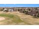 Aerial view of homes bordering a golf course, featuring well-manicured lawns and landscaping at 7683 S Biloxi Way, Aurora, CO 80016
