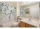 Clean bathroom with a shower featuring a decorative curtain, a toilet, and an oak vanity at 7683 S Biloxi Way, Aurora, CO 80016