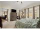 Spacious bedroom with large windows, plush carpeting, and elegant furnishings at 7683 S Biloxi Way, Aurora, CO 80016