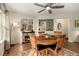 Dining room with hardwood floors, a ceiling fan, and views into adjacent living spaces at 7683 S Biloxi Way, Aurora, CO 80016