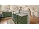 Charming kitchen featuring green cabinets, stainless steel appliances, and hardwood flooring at 7683 S Biloxi Way, Aurora, CO 80016