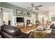 Cozy living room with a fireplace, mantel, hardwood floors, and comfortable seating arrangement at 7683 S Biloxi Way, Aurora, CO 80016