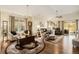 Spacious living room featuring hardwood floors, large windows, a ceiling fan, and comfortable seating at 7683 S Biloxi Way, Aurora, CO 80016