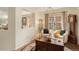 Cozy sitting area with hardwood floors, neutral furniture, and a stained glass window at 7683 S Biloxi Way, Aurora, CO 80016