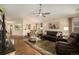 View of a comfortable living room with hardwood floors, and a view into other rooms in the home at 7683 S Biloxi Way, Aurora, CO 80016
